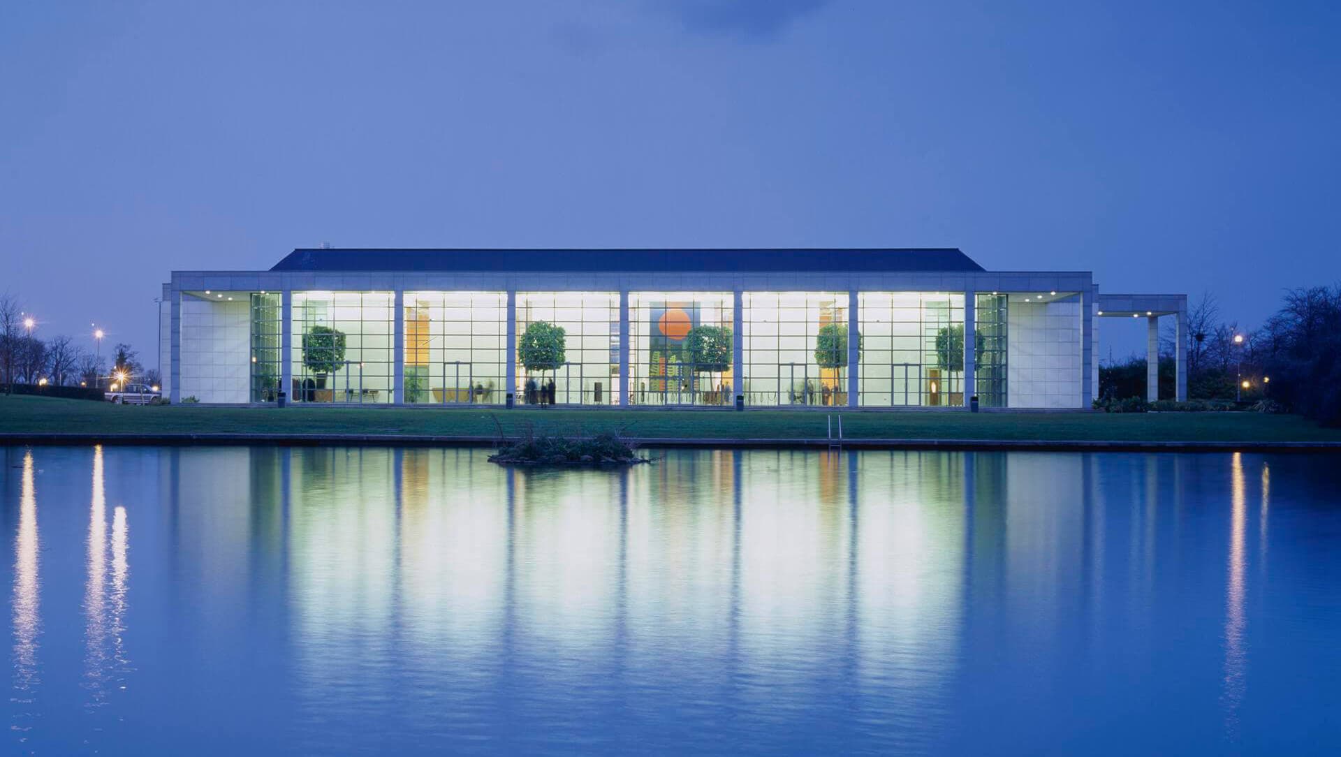 O'Reilly Hall at night reflected in the campus lake